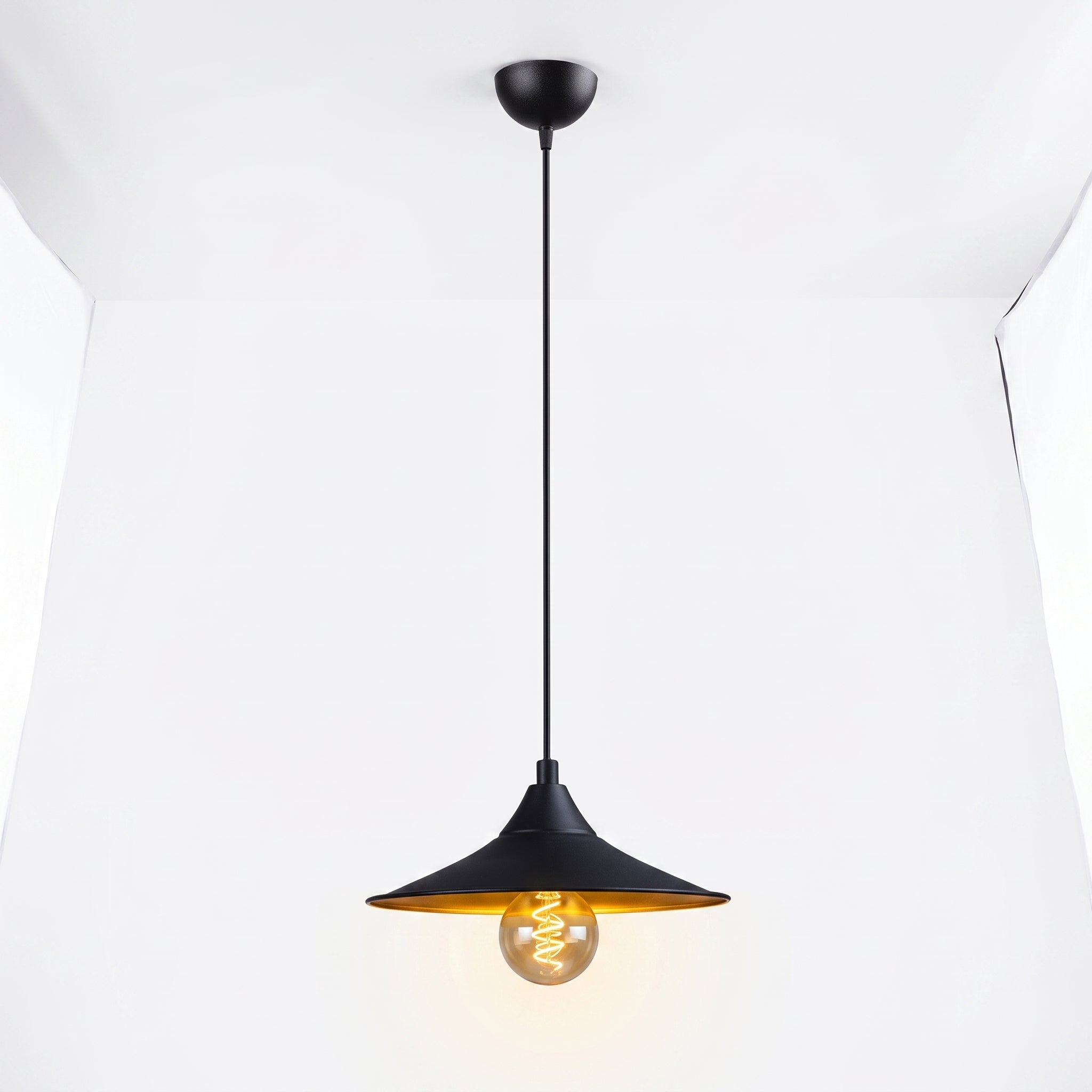 Lustre noir et doré allumé - halo doré chaleureux