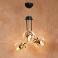 Lustre 3 globes ambrés structure noire détails dorés design moderne IP40