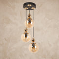 Suspension cascade 3 globes ambré noir mat et doré design moderne