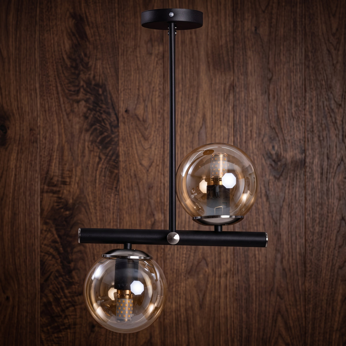 Lustre 2 globes en verre ambré transparent avec structure noire diagonale